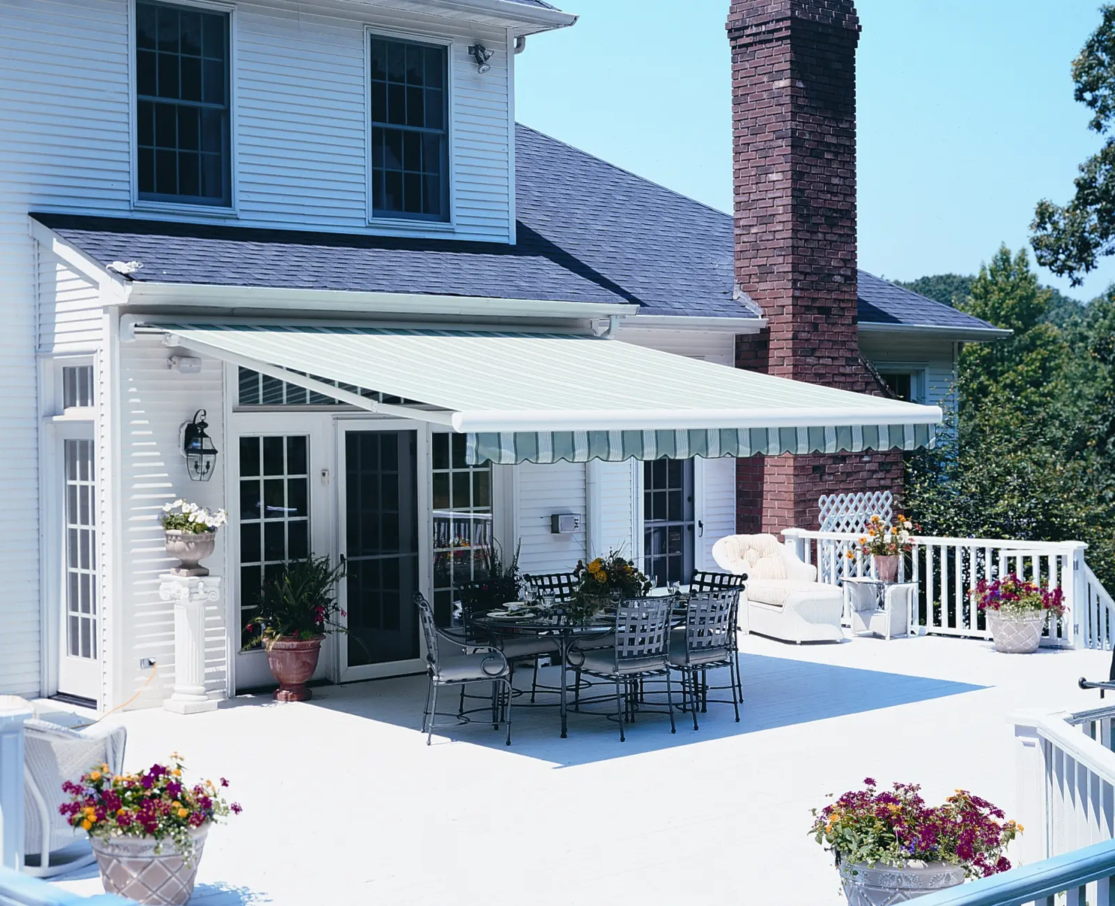Aristocrat retractable awning shading an outdoor seating area.